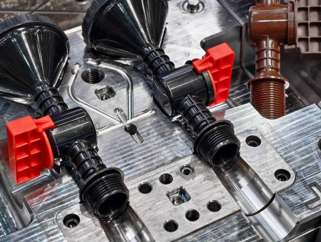 Metal molds for plastic injection molding showcase intricate design and precise engineering in a manufacturing facility