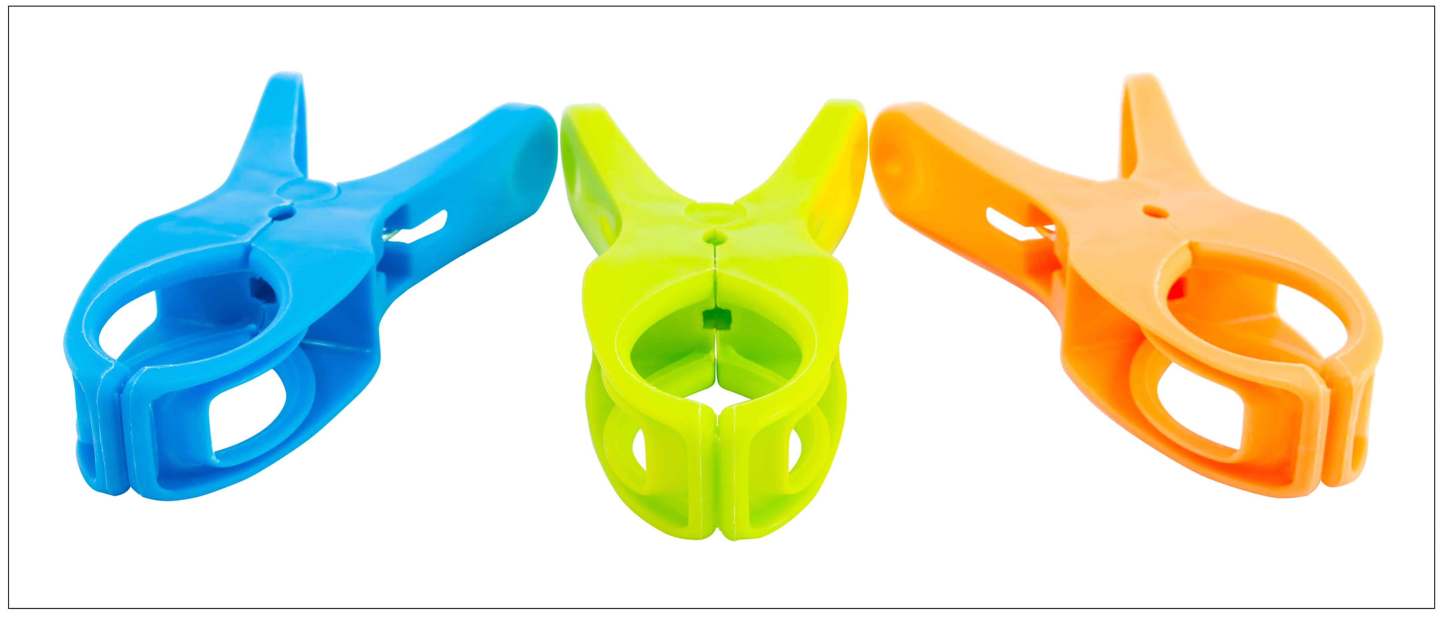 Three plastic spring clamps isolated over white background - ICOMold®